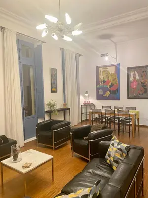 a bedroom with a bed and a painting on the wall at La Suite de la Cathédrale in Narbonne