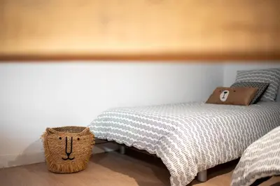 a bedroom with a bed and a basket next to it at Le Blackwood in Mazamet