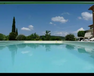 a large swimming pool with blue water at Villa les Deux Cypres in Saint-Laurent-de-la-Cabrerisse
