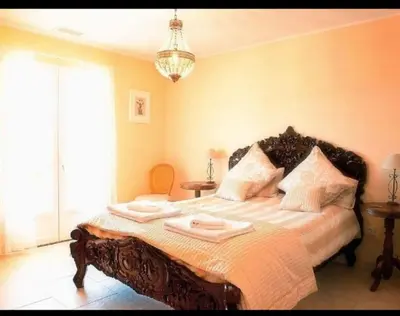 a bedroom with a bed with two towels on it at Villa les Deux Cypres in Saint-Laurent-de-la-Cabrerisse