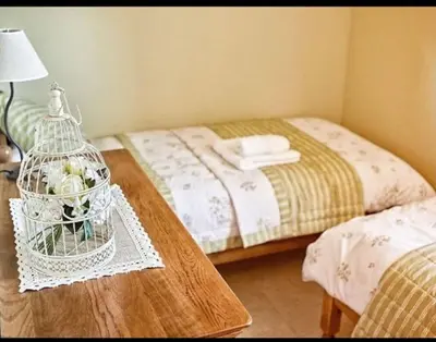 a bedroom with a bed and a table with a cage with flowers at Villa les Deux Cypres in Saint-Laurent-de-la-Cabrerisse