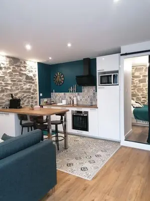 a kitchen with a table and a dining room at Charmant appartement de village in Pennautier
