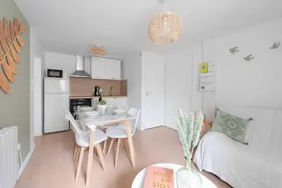 a kitchen and a living room with a table and chairs at Le Cottage in Mazamet