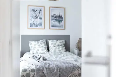 a bedroom with a bed and three pictures on the wall at Le Polaire in Mazamet