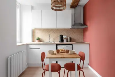a small kitchen with a table and chairs in a room at Agréable studio cosy entièrement rénové in Mazamet
