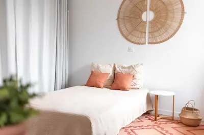 a bedroom with a bed with orange pillows on it at Agréable studio cosy entièrement rénové in Mazamet