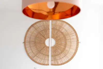 a rattan fan is hanging on a wall at Agréable studio cosy entièrement rénové in Mazamet