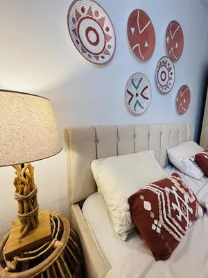 a bedroom with a bed with plates on the wall at Les cigales - souplex cosy et calme in Mas-Saintes-Puelles