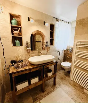 a bathroom with a sink and a toilet at Les cigales - souplex cosy et calme in Mas-Saintes-Puelles