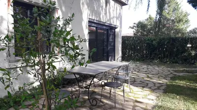 a table and chairs sitting outside of a house at L' Abri du Saule in Aussillon