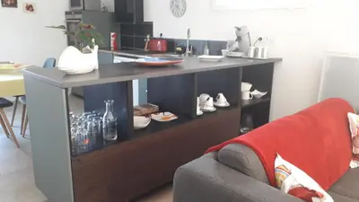 a living room with a table with shoes on it at L' Abri du Saule in Aussillon