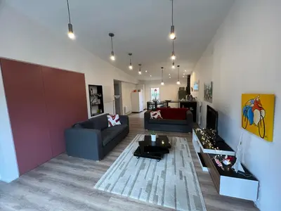 a living room with two couches and a table at L' Abri du Saule in Aussillon