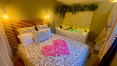 a bedroom with a bed with a pink heart on it at L'annexe spa du Tropical Lodge in Narbonne