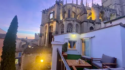 a view of a castle from the balcony of a house at L'annexe spa du Tropical Lodge in Narbonne