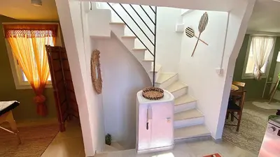 a staircase in a home with a white stair case at L'annexe spa du Tropical Lodge in Narbonne