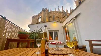 a bottle of wine sitting on a wooden table with wine glasses at L'annexe spa du Tropical Lodge in Narbonne