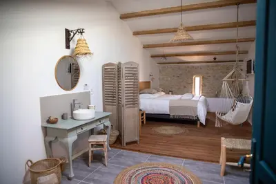 a bedroom with a bed and a hammock in it at Bessire Chambres & table d'hôtes in Belflou