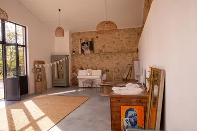 a large room with a kitchen with a table at Bessire Chambres & table d'hôtes in Belflou