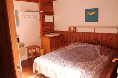 a bedroom with a bed and a sink at Panorama Gîtes Certes in Gaudiès