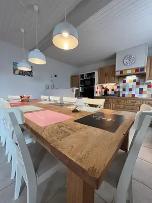 a kitchen with a wooden table and white chairs at Le Villerouge - 14 Personnes - Piscine in Fabrezan