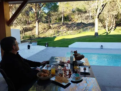 a man sitting at a table with food on it at Le Clos FMR - Romain in Malves-en-Minervois