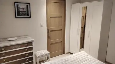 a bedroom with a bed and a dresser and a closet at Les Remparts in Caudiès-de-Fenouillèdes