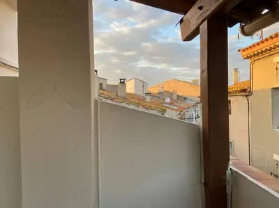 a view from an open window of a white garage at Maison au cœur du village de Gruissan in Gruissan