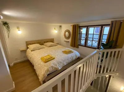a bedroom with a bed with two towels on it at Charmant appartement - proche château cité in Carcassonne