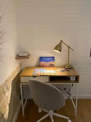 a desk with a chair and a lamp on it at Charmant appartement - proche château cité in Carcassonne