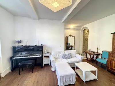 a living room with a piano and a couch at L'écrin Lauragais - Grande maison, 3 chambres 3sdb in Villefranche-de-Lauragais