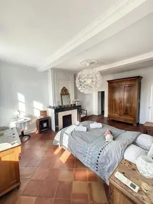 a bedroom with a bed with a stuffed animal on it at L'écrin Lauragais - Grande maison, 3 chambres 3sdb in Villefranche-de-Lauragais