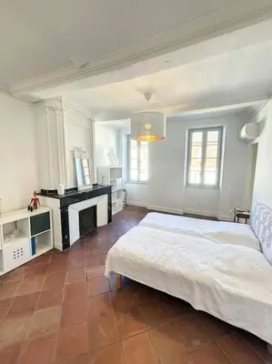 a white bedroom with a bed and a fireplace at L'écrin Lauragais - Grande maison, 3 chambres 3sdb in Villefranche-de-Lauragais