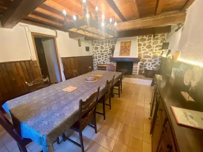 a dining room with a table and a fireplace at Maison de campagne à Camps-sur-l'Agly avec vue sur lac in Camps-sur-lʼAgly