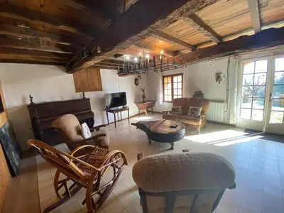 a living room filled with furniture and a piano at Maison de campagne à Camps-sur-l'Agly avec vue sur lac in Camps-sur-lʼAgly