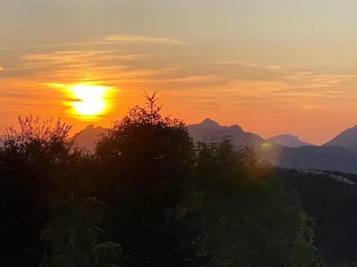 a sunset in the mountains with the sun in the sky at Maison confortable au cœur de la nature près de Camps-sur-l'Agly in Camps-sur-lʼAgly