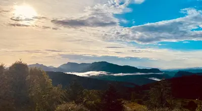 a view of a mountain valley with clouds in the sky at Maison confortable au cœur de la nature près de Camps-sur-l'Agly in Camps-sur-lʼAgly