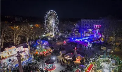 an amusement park with a ferris wheel at night at Appartement Cité Médiévale Carcassonne in Carcassonne