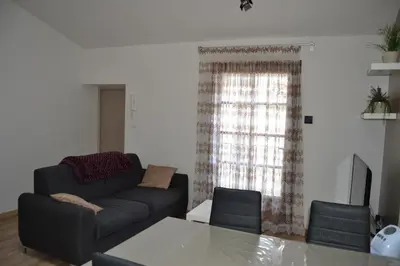 a living room with a couch and a table at Appartement Cité Médiévale Carcassonne in Carcassonne