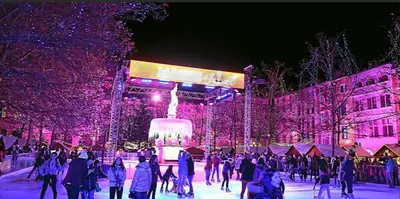 a group of people skating on a rink with christmas lights at Appartement Cité Médiévale Carcassonne in Carcassonne