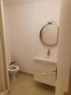 a bathroom with a toilet and a mirror on the wall at Maison de village in Ventenac-Cabardès