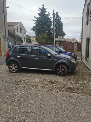 a black car parked on the side of a street at Maison de village in Ventenac-Cabardès