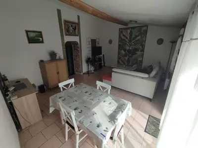 a living room with a table and chairs and a couch at Repos en campagne in Pexiora