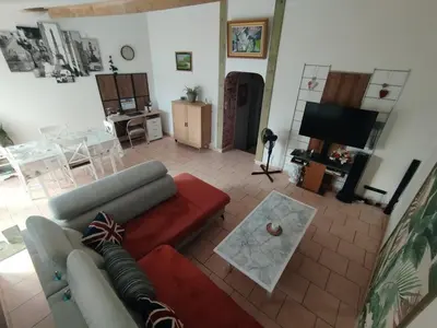 a living room with a couch and a table at Repos en campagne in Pexiora