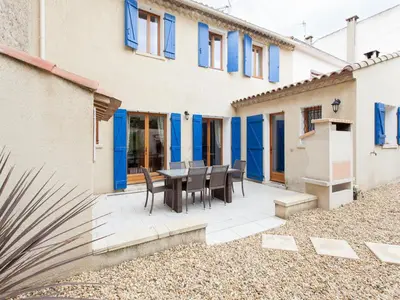 a patio with a table and chairs in front of a building at Hirondelle - A beautiful rental home in the heart of The Cathar Country in Capestang
