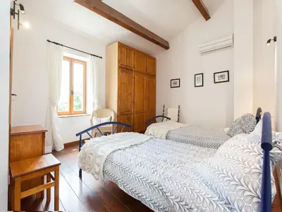 a bedroom with two beds and a window at Hirondelle - A beautiful rental home in the heart of The Cathar Country in Capestang