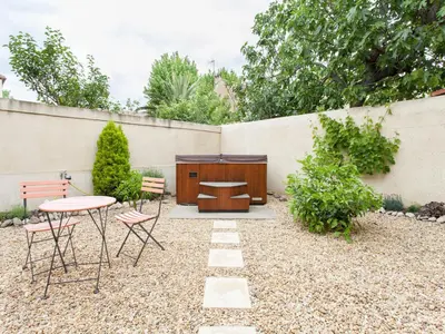 a patio with a table and chairs and a fence at Hirondelle - A beautiful rental home in the heart of The Cathar Country in Capestang