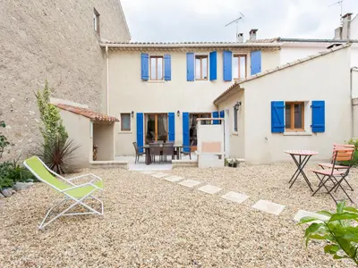 a house with a yard with chairs and a table at Hirondelle - A beautiful rental home in the heart of The Cathar Country in Capestang