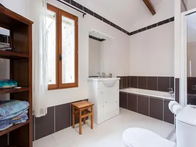 a bathroom with a tub and a toilet and a sink at Hirondelle - A beautiful rental home in the heart of The Cathar Country in Capestang