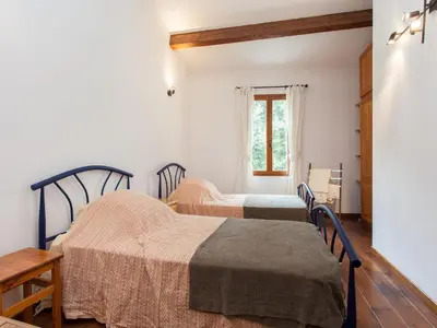 a bedroom with two beds and a window at Hirondelle - A beautiful rental home in the heart of The Cathar Country in Capestang
