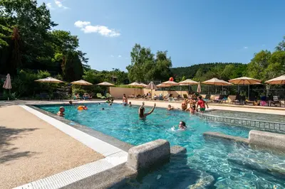 a group of people swimming in a swimming pool at Camping LA SERRE in Aigues-Vives
